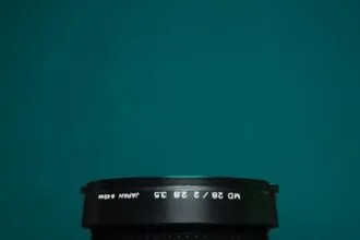 black camera lens on green surface